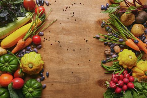 Frame Of Healthy Food Vegetables And Beans On Wooden Table Stock