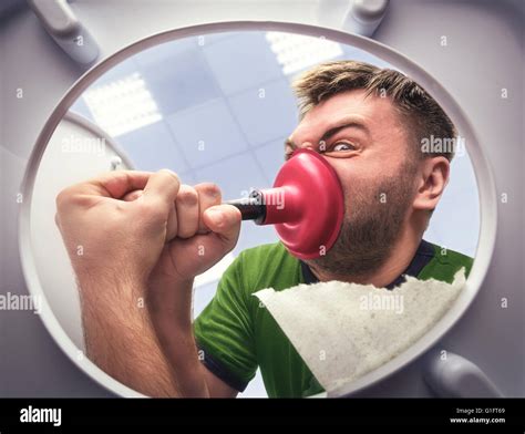 Man with cup plunger Stock Photo - Alamy