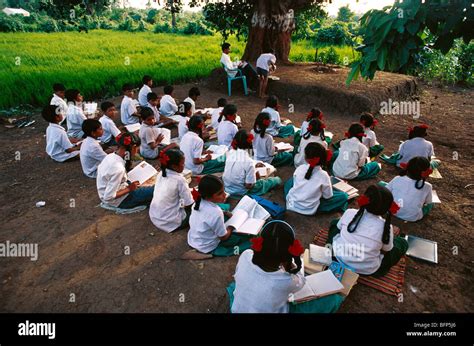 Indian children education under a tree ; open air rural school ...