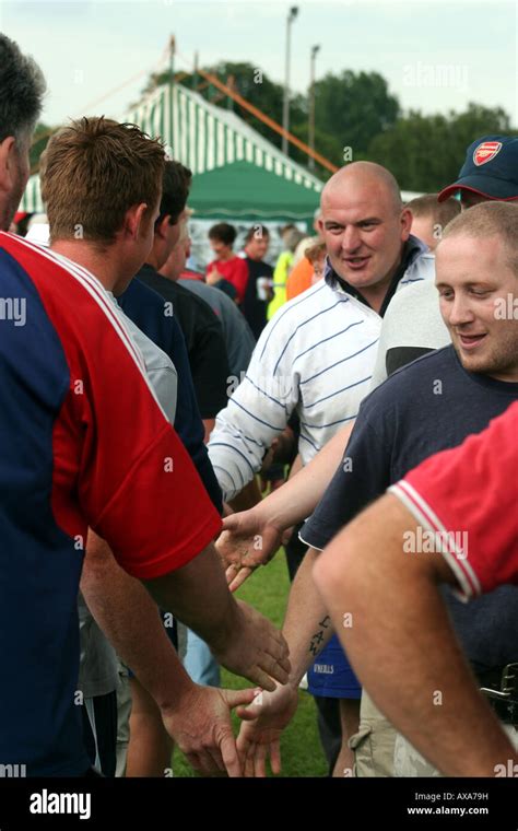 Two tug of war teams shake hands Stock Photo - Alamy