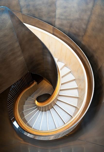 Premium Photo | A spiral staircase with a gold colored spiral staircase.