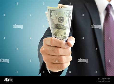 Businessman hand grabbing money, US dollar (USD) bills Stock Photo - Alamy