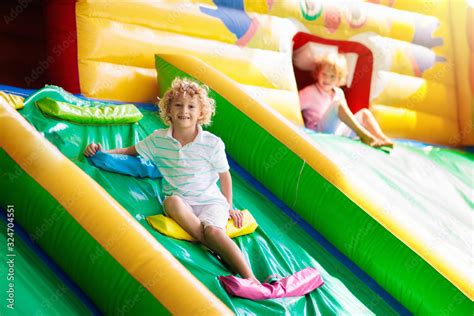 Child jumping on playground trampoline. Kids jump. Stock Photo | Adobe ...