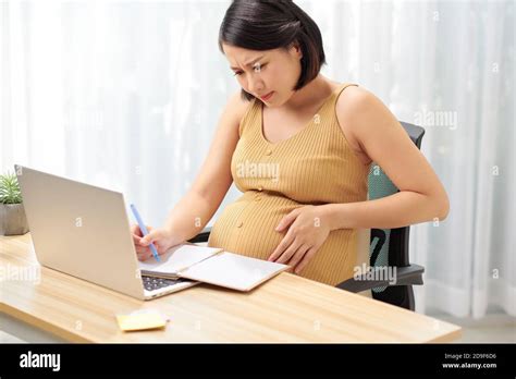 Tired pregnant woman working Stock Photo - Alamy