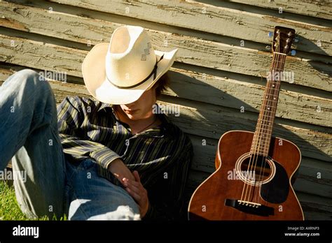 Sleeping cowboy with guitar Stock Photo - Alamy