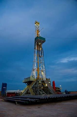 a) Onshore drilling rig located in Texas, USA and b) Offshore jack-up ...