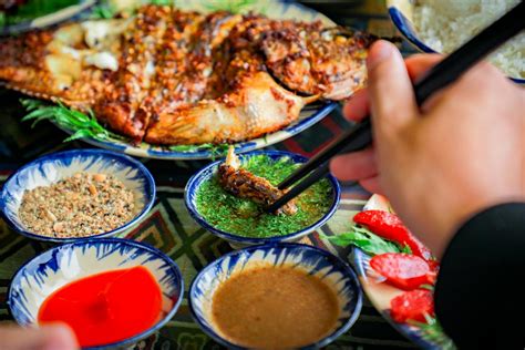 Close-up of a Person Grabbing Food from the Table with Chopsticks ...