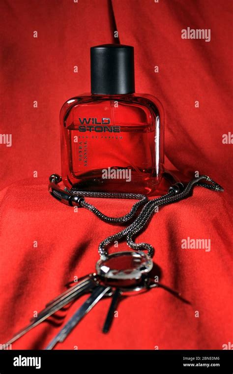 Red color men perfume bottle isolated on red background with female ...