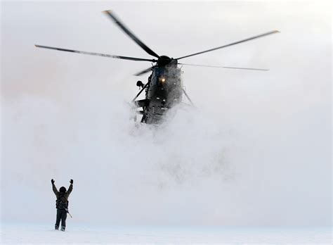 A Royal Navy Sea King helicopter landing in a whiteout situation in ...