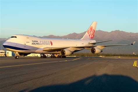 China Airlines Boeing 747F hits baggage pallets, suffers engine damage ...