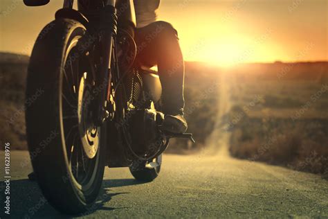 On a roaring motorcycle at sunset Stock Photo | Adobe Stock