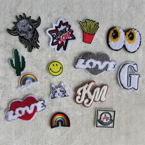 various patches and stickers are displayed on a white surface ...