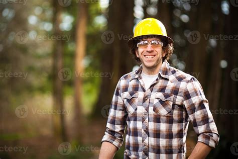 Man Lumberjack in the Woods with Safety Gear 903734 Stock Photo at Vecteezy