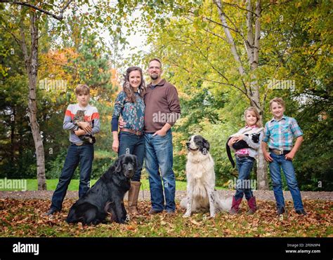 Happy family of five with dogs and cats by a country road Stock Photo ...