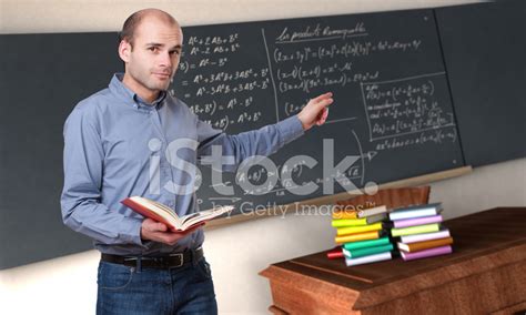 Teacher Pointing To A Blackboard Stock Photo | Royalty-Free | FreeImages