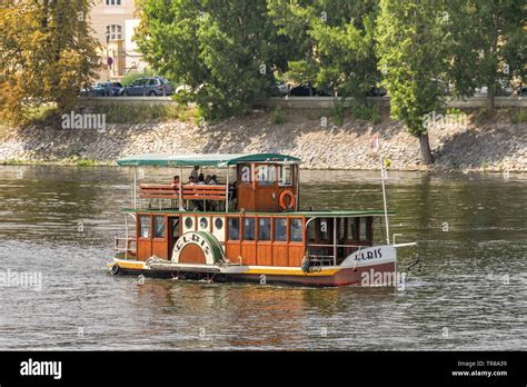 PRAGUE, CZECH REPUBLIC - JULY 2018: Small wooden tourist river cruise ...