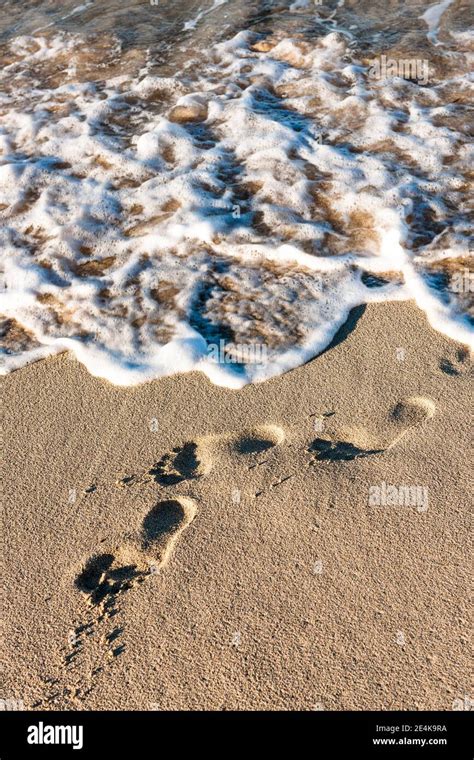 Footprints in beach sand Stock Photo - Alamy