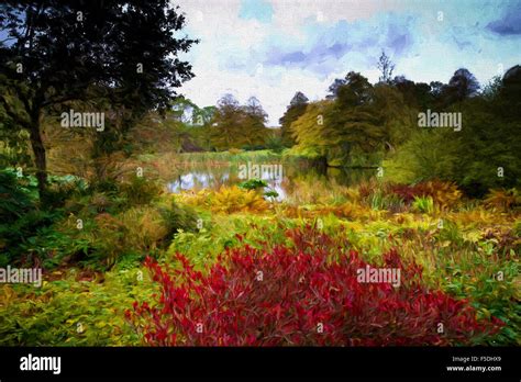 English country garden scene in autumn with lake and red and plants ...