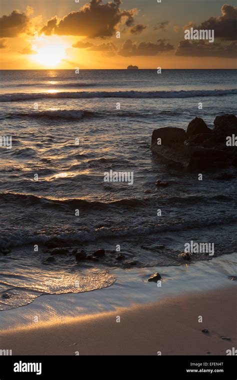 Barbados beach at sunset with cruise ship on horizon Stock Photo - Alamy