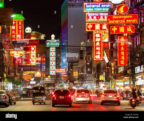 Yaowarat Road in Chinatown, neon signs at night, people and cars ...