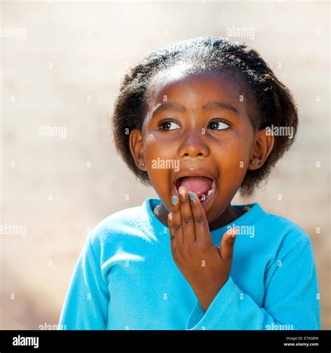 Close up portrait of little African girl with surprised face expression ...