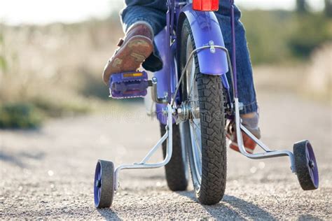 Learning To Ride a Bike with Training Wheels Stock Image - Image of ...