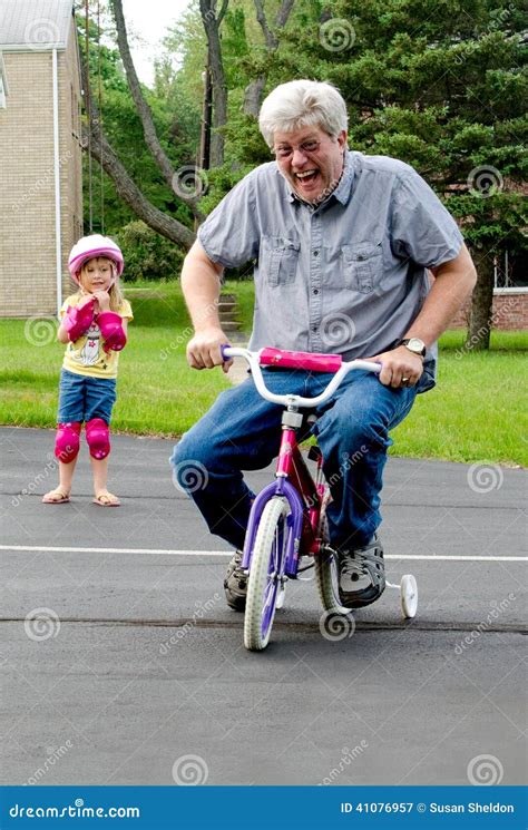 Learning To Ride A Bike With Training Wheels Stock Image - Image: 41076957