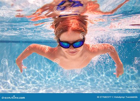 Child in Swimming Pool Underwater. Kid Underwater Swim. Child Splashing ...