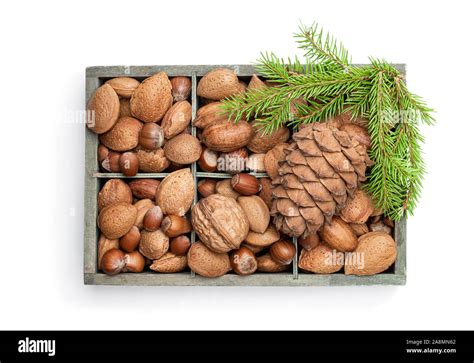 Wooden box with mixed nuts isolated on white. Christmas set Stock Photo ...