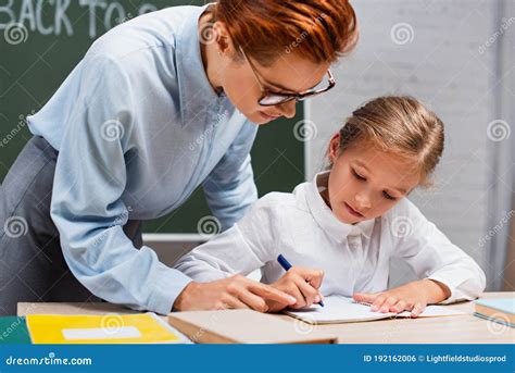 Attentive Teacher Pointing with Finger Near Stock Photo - Image of ...