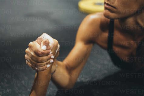 Two women in good shape doing arm wrestling challenge in a gym stock photo