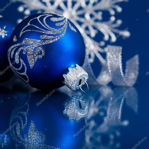 Blue and silver christmas ornaments on dark blue xmas background with ...