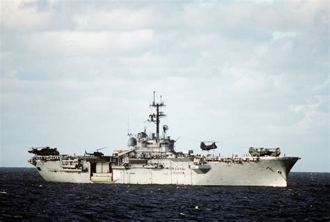 A CH-46 Sea Knight helicopter hovers over the flight deck of the ...