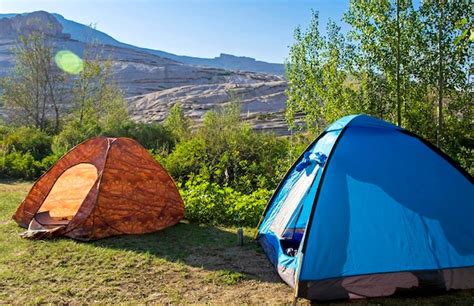 Premium Photo | Camping tents near mountains in the clearing