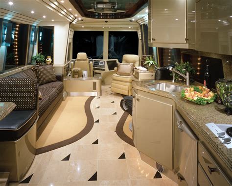 the interior of a luxury motorhome with kitchen and living room area in it