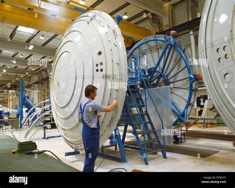 Aircraft mechanic assembling 1/6-segment pressure bulkhead during Stock ...