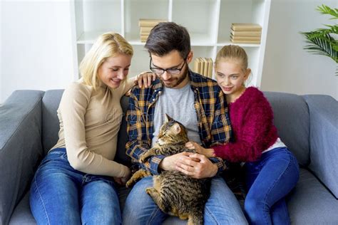 Family with a cat stock image. Image of adult, child - 99305705