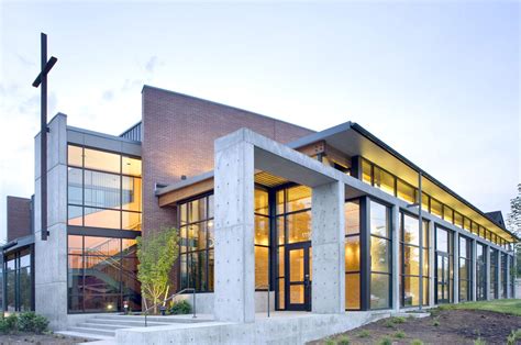 Modern Church Design with Large Windows and Cross on Roof