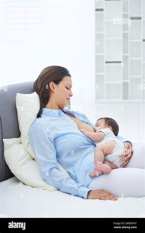 Breastfeeding, reclining position Stock Photo - Alamy