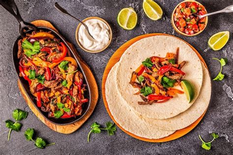 Premium Photo | Fajitas with colored pepper and onions served with ...