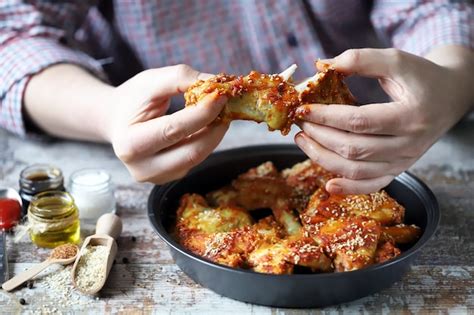 Premium Photo | The man is eating chicken wings. fried chicken wings.