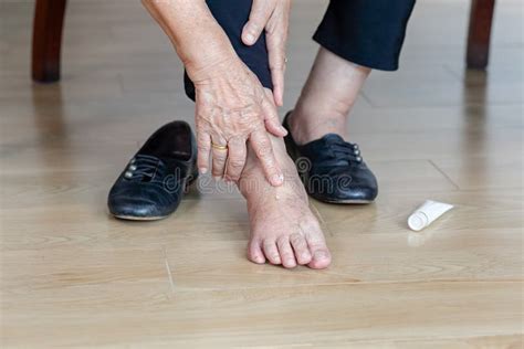 Elderly Woman Putting Cream on Swollen Feet Stock Image - Image of ...