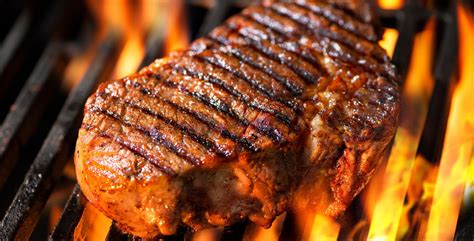 Beef steak on the grill with flames - BBQ Tips