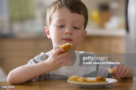 Boy Eating Chicken Nuggets Photos and Premium High Res Pictures - Getty ...