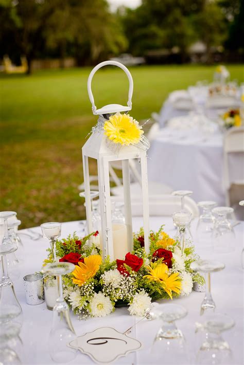 White Lantern Centerpiece With Yellow Daisy