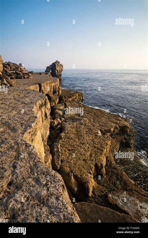 Rocky cliff landscape with sunset over ocean Stock Photo - Alamy