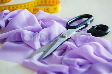 Scissors and a fabric | Stock image | Colourbox