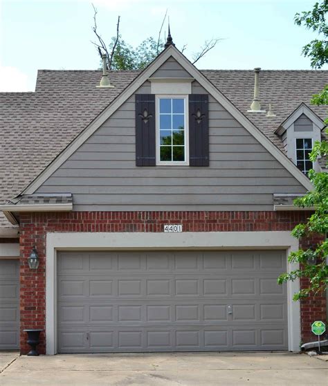 Gray House Exterior with Two Garage Doors and Windows