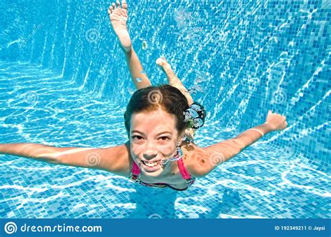 Child Swims Underwater in Swimming Pool, Little Active Girl Dives and ...