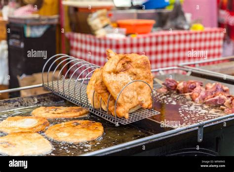 Traditional Hungarian street food Langos at fair. Langos frying in ...